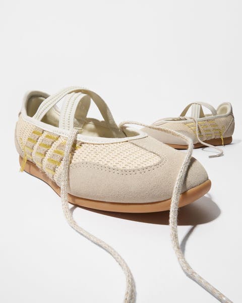 A pair of ballerina-style sneakers.