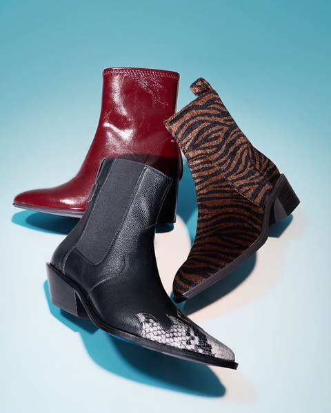 "Three ankle boots arranged together in red leather, black snake print, and brown zebra print.