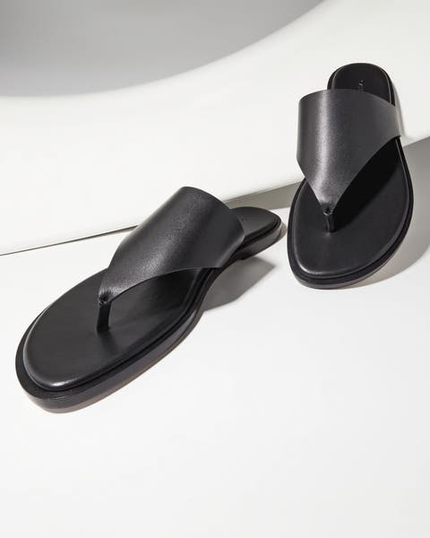 A pair of black thong sandals.