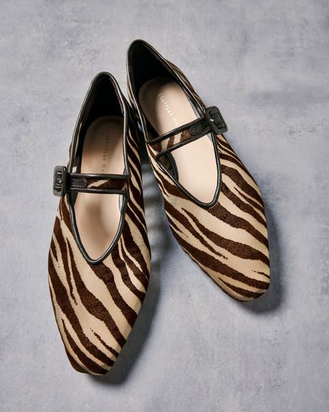 Product shot of animal print flats.