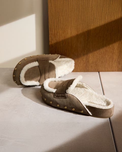 Suede clogs with shearling and metal rivets.