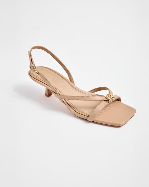 Tan sandal with a kitten heel.