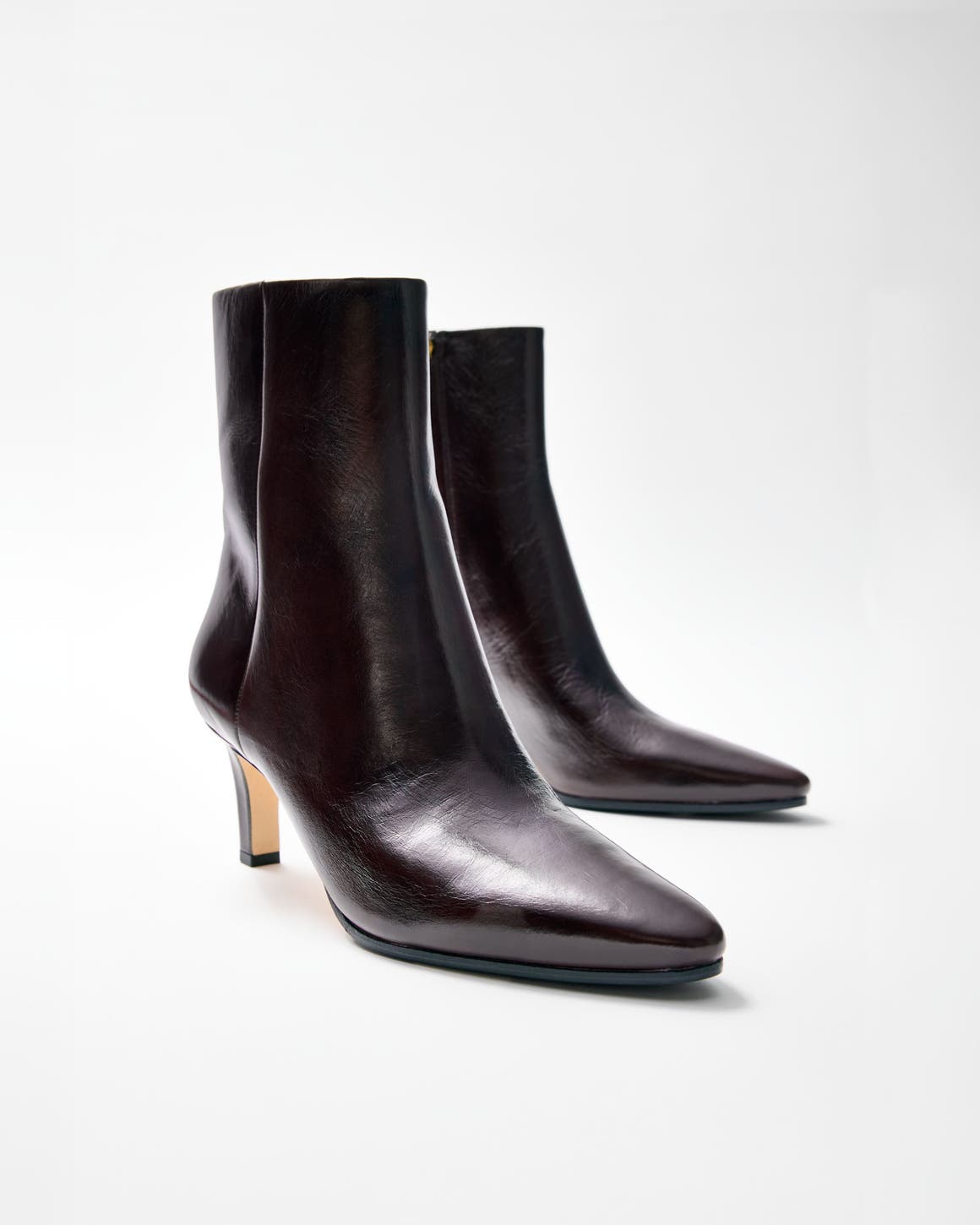Black pointed-toe stiletto ankle boots.