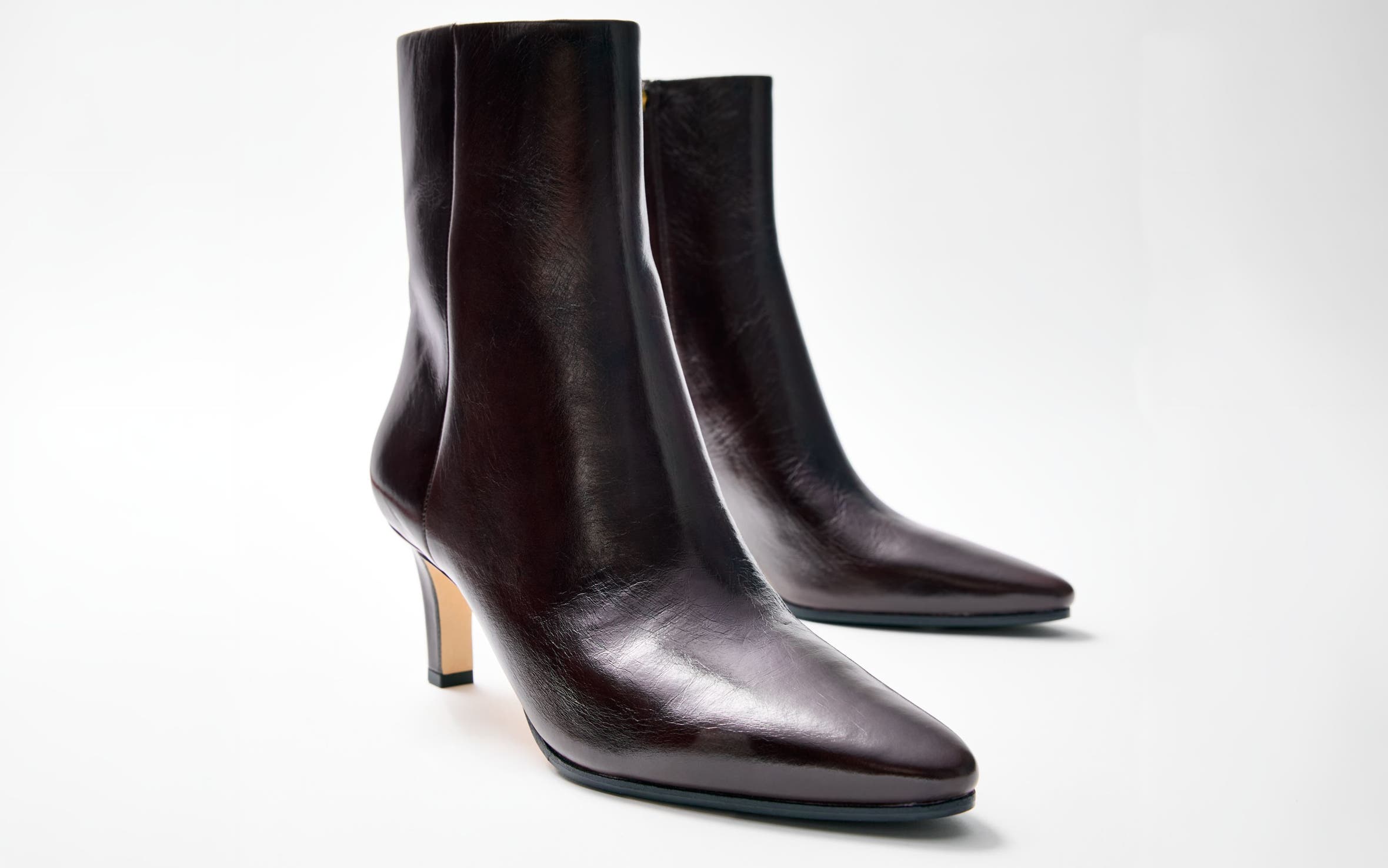 Black pointed-toe stiletto ankle boots.