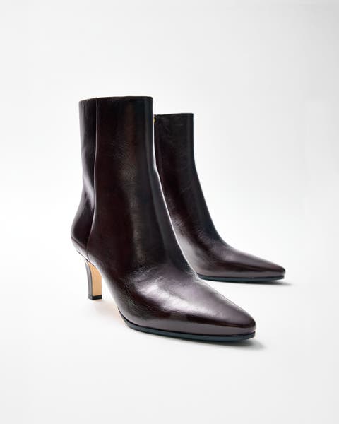 Black pointed-toe stiletto ankle boots.