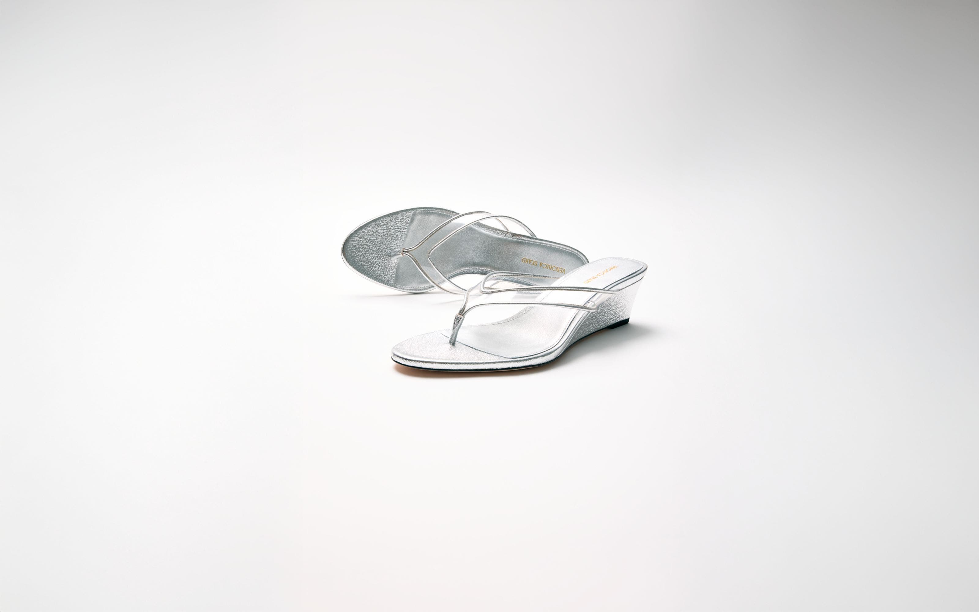 Metallic flip-flop wedge sandals.