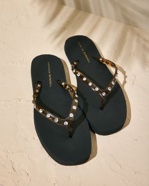Black embellished flip-flops.