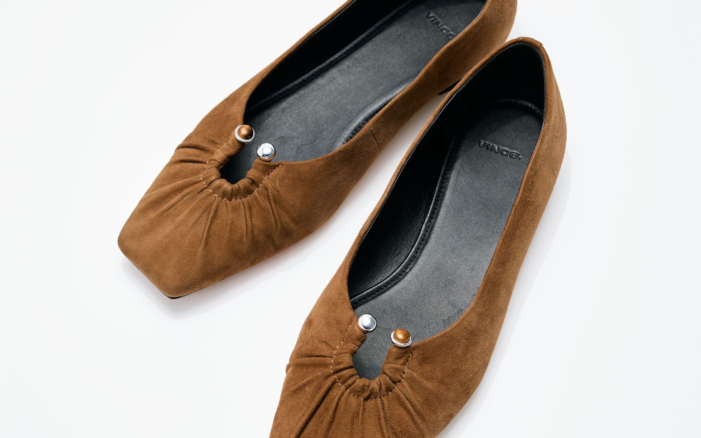 Brown suede flats with keyhole detail.