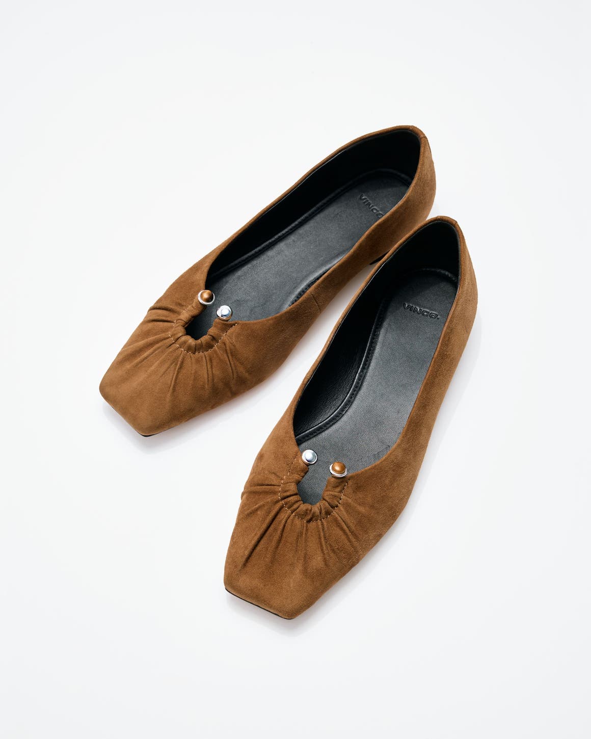 Brown suede flats with keyhole detail.