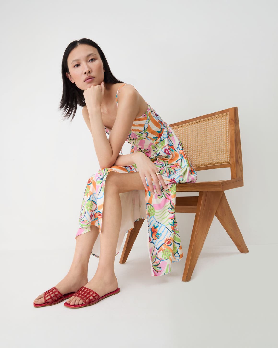 A woman wearing red jelly slides.