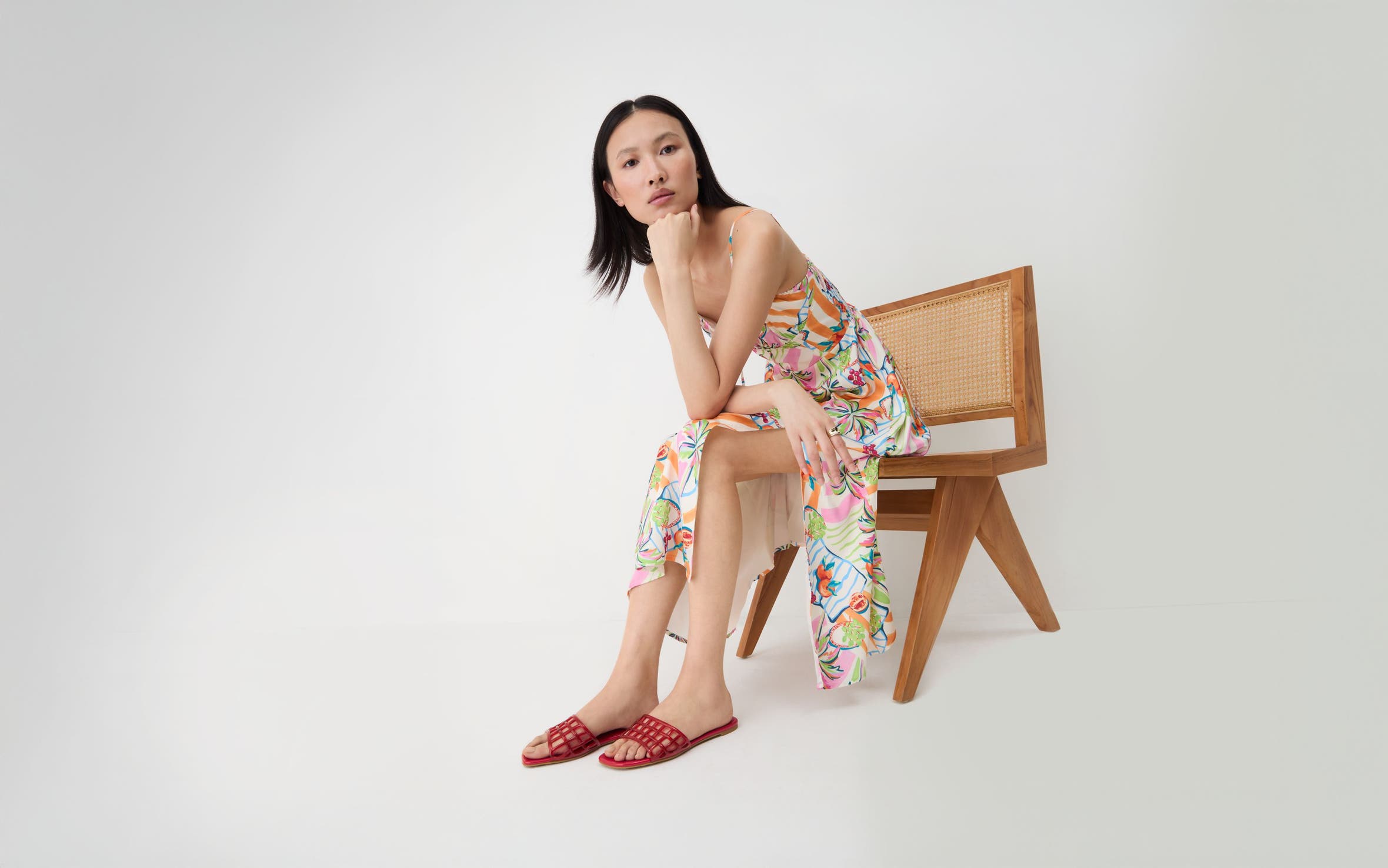 A woman wearing red jelly slides.