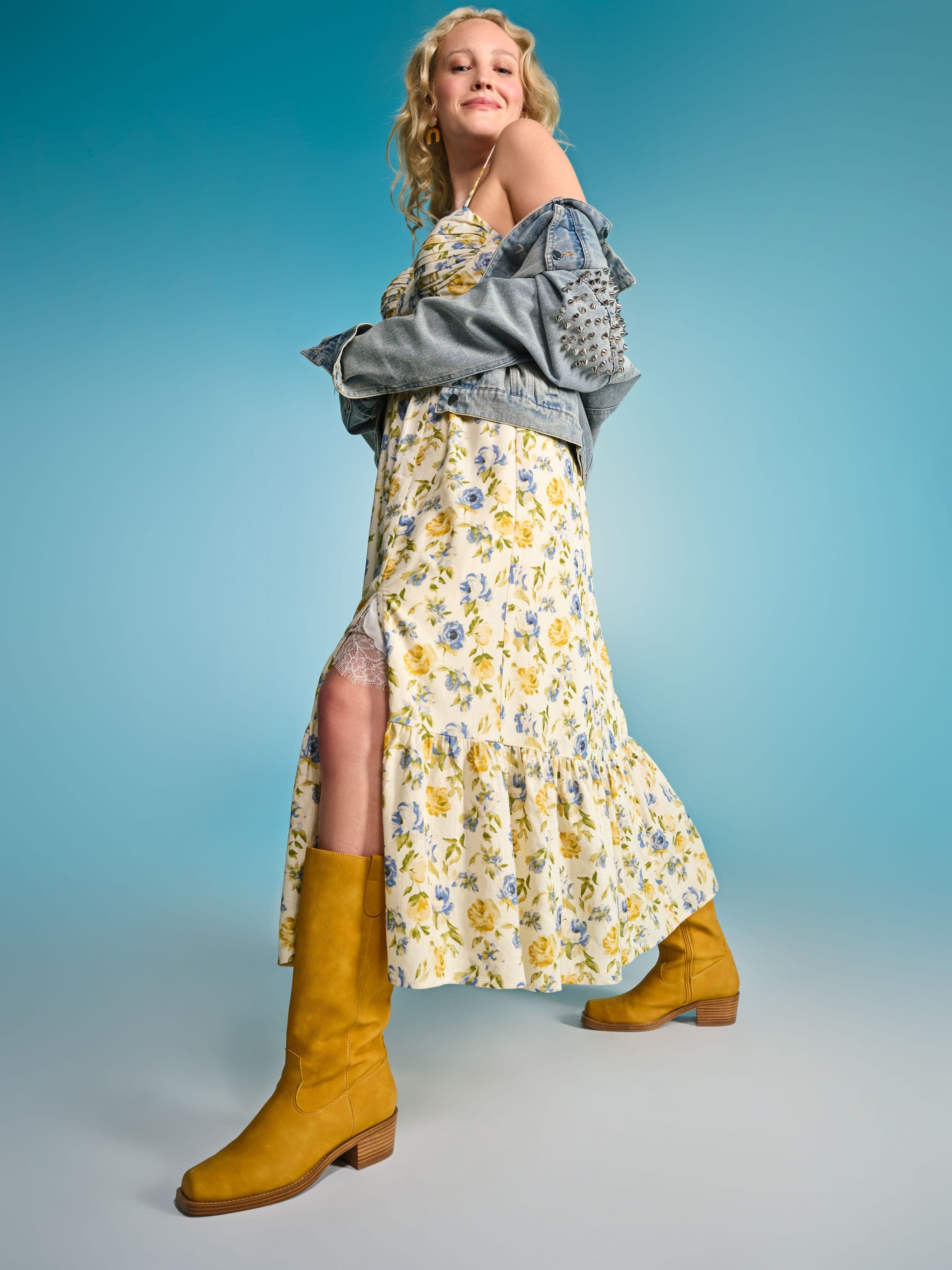 Women in floral dress, denim jacket and boots.