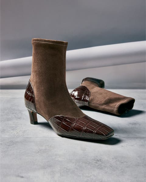 A pair of brown suede and croc-detail ankle boots.