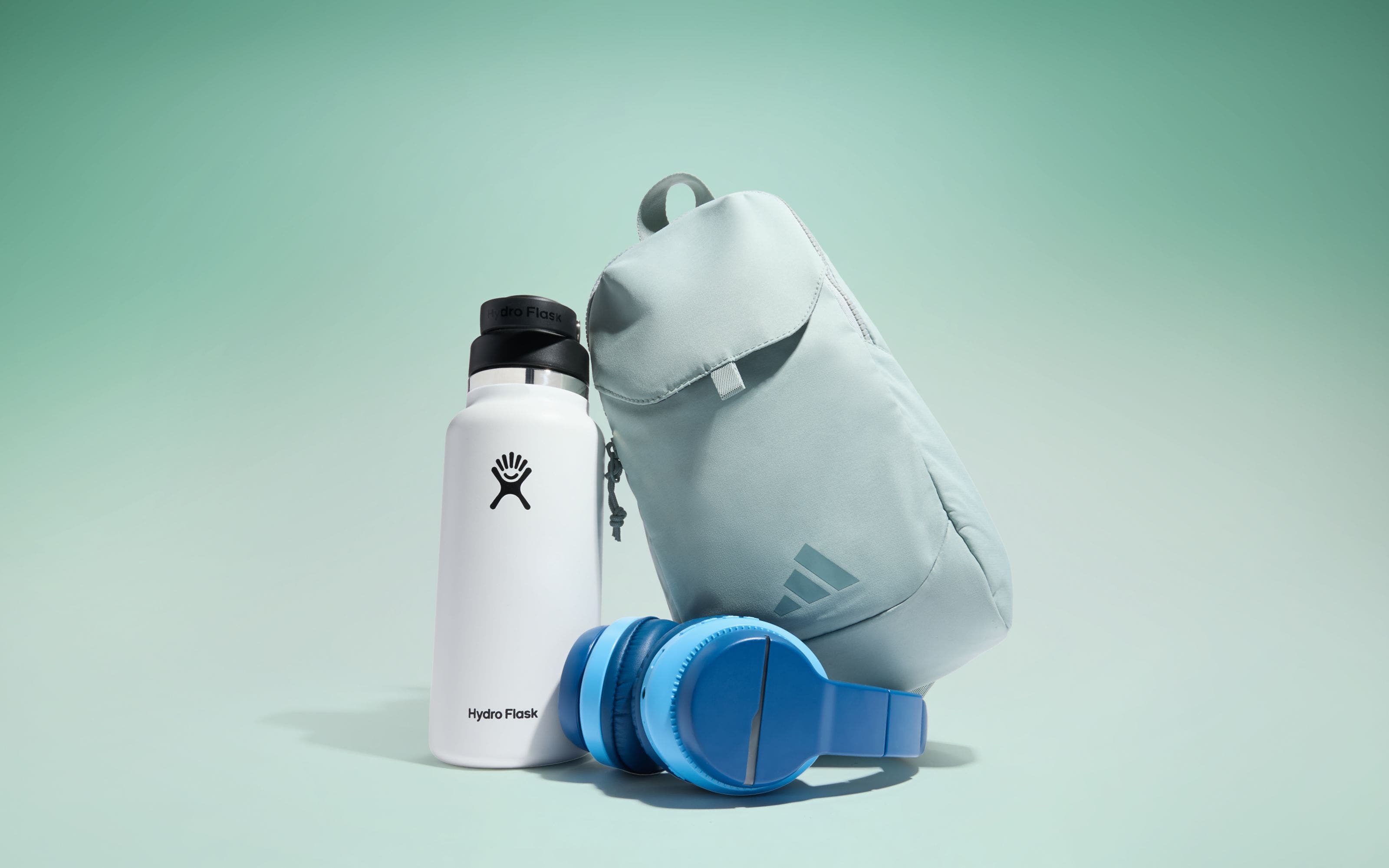 A water bottle, backpack and pair of headphones.