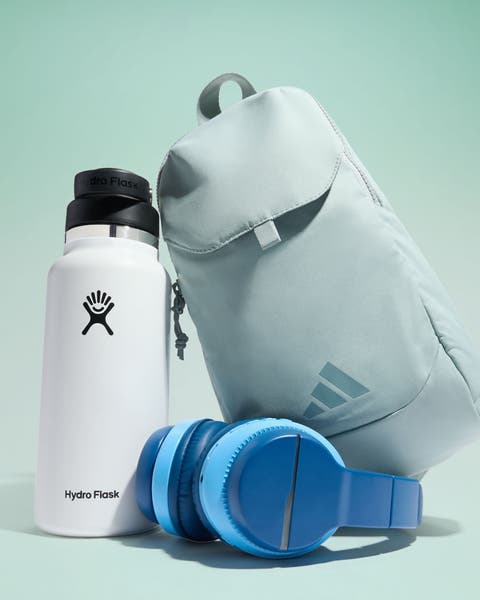 A water bottle, backpack and pair of headphones.