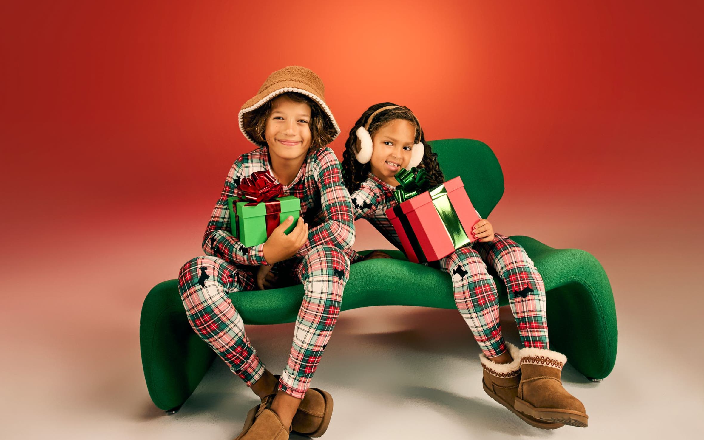 Kids wearing matching pajamas and UGG slippers. 