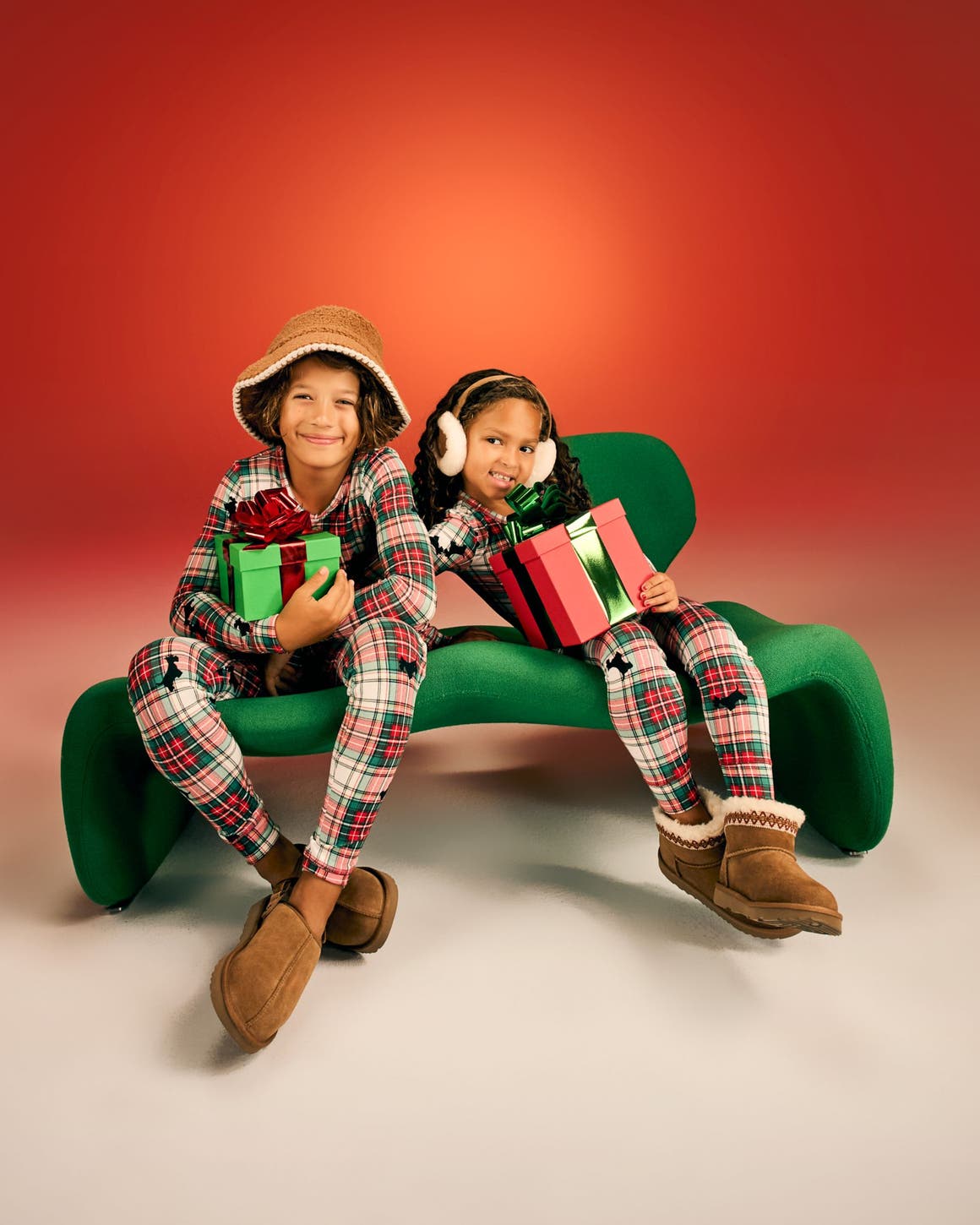Kids wearing matching pajamas and UGG slippers. 