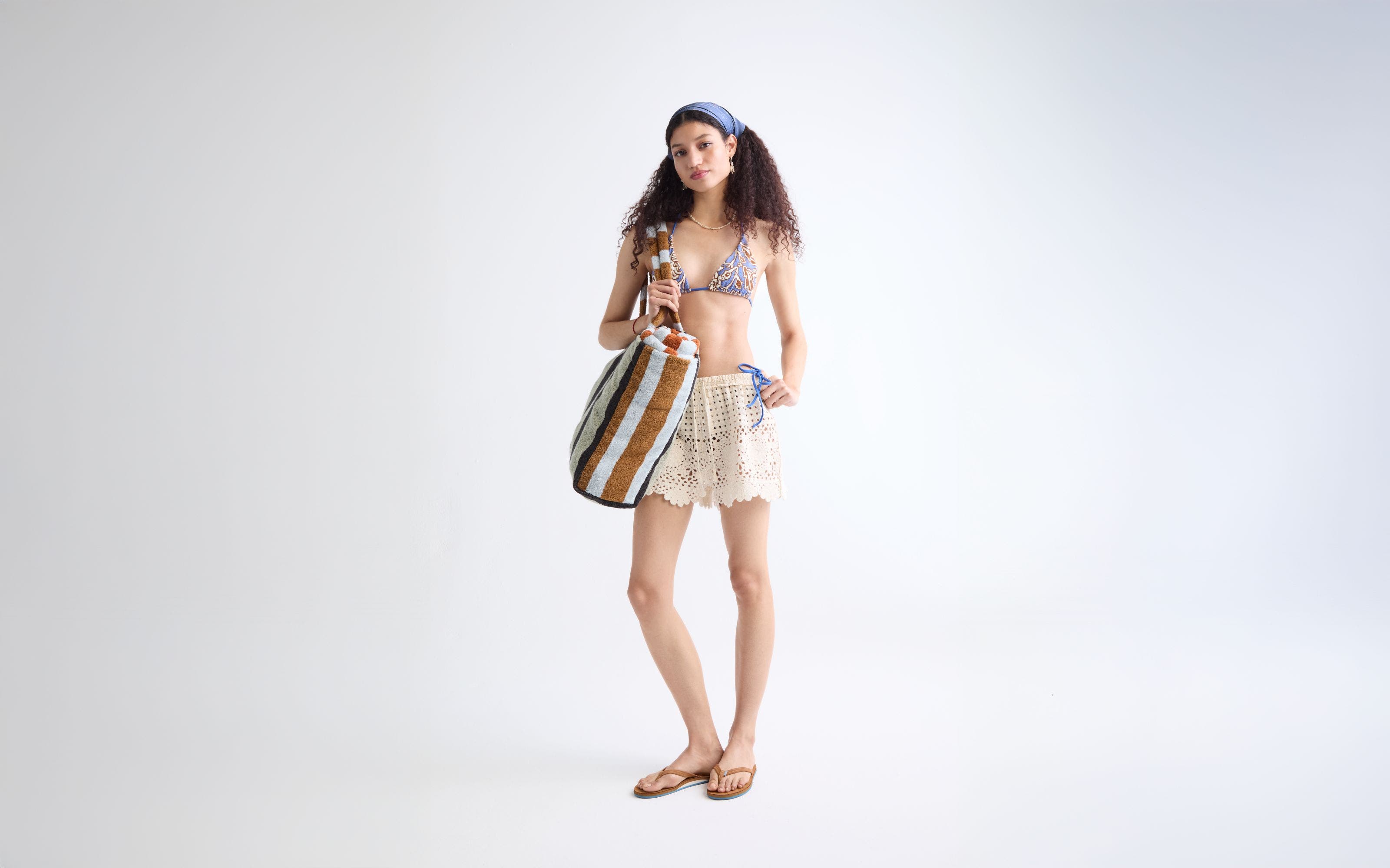 Woman wearing swim top and crochet shorts.