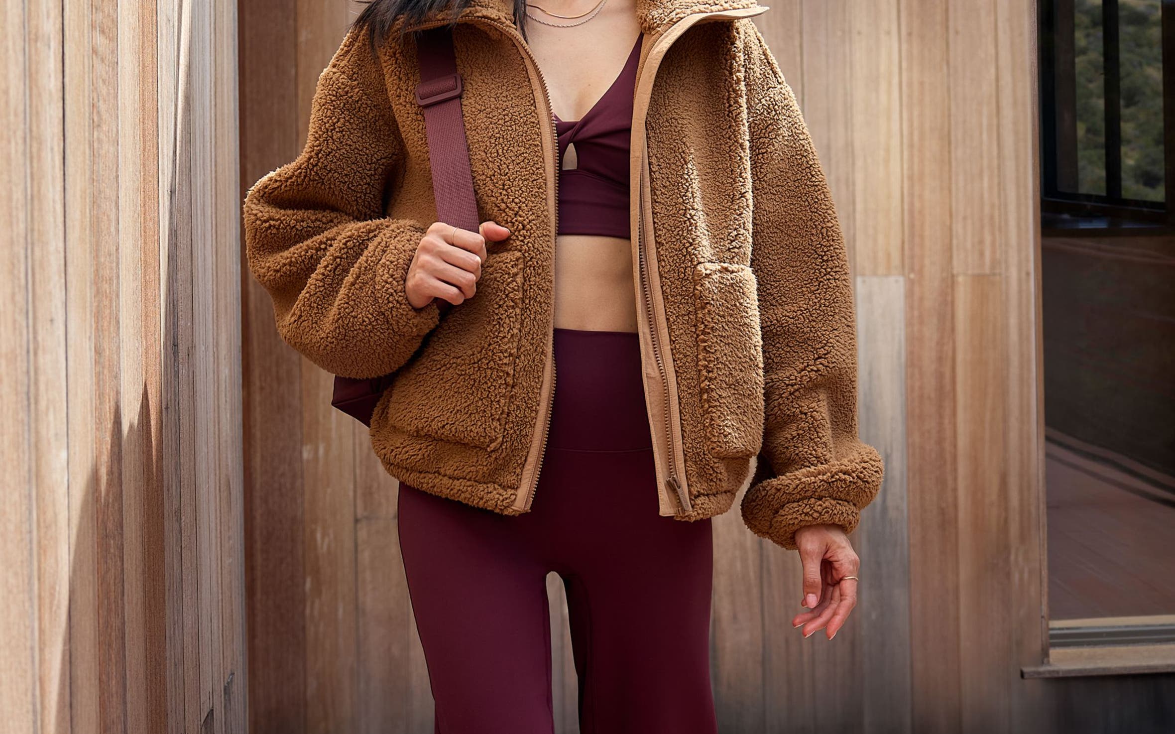 Woman wearing an activewear set and jacket.