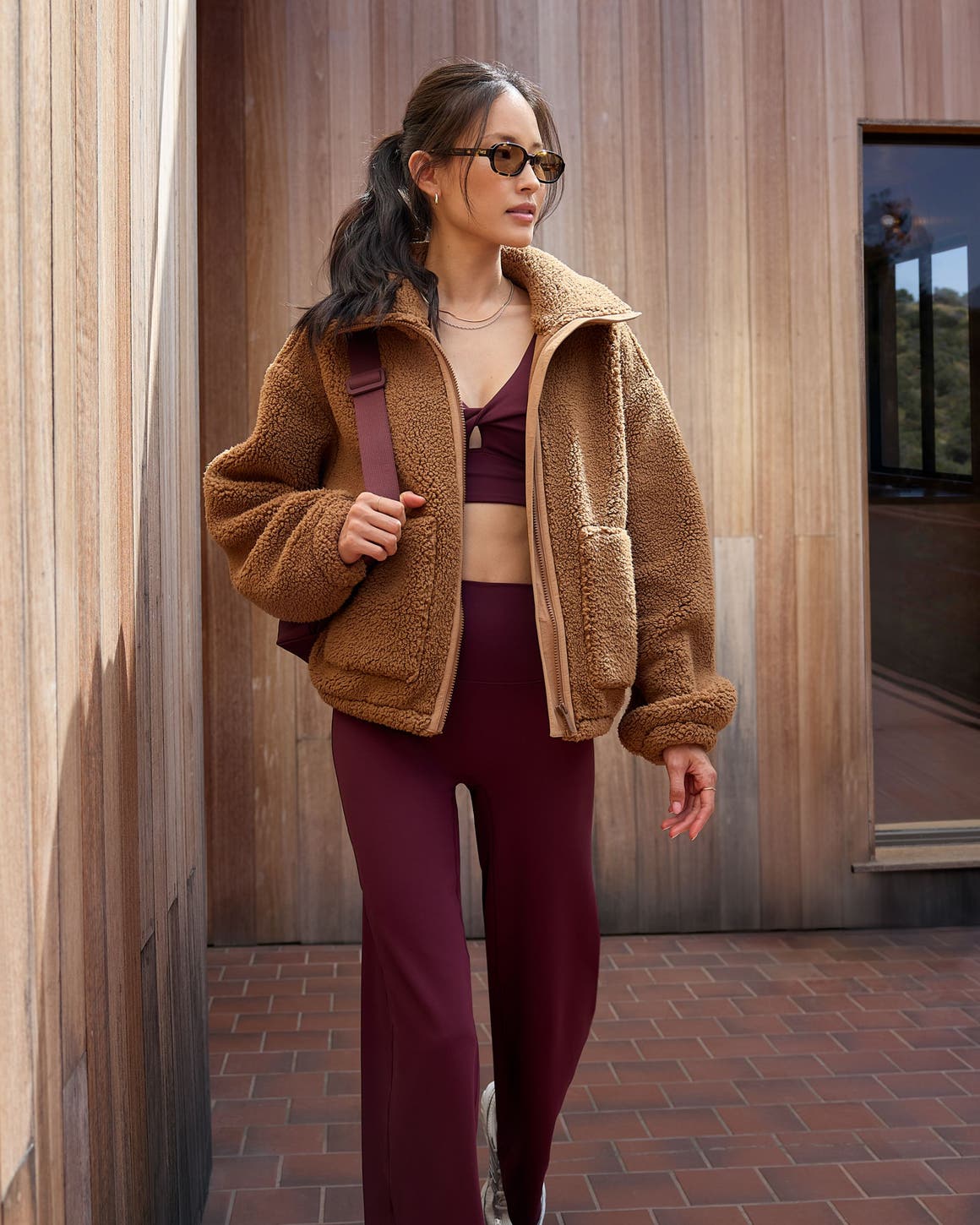 Woman wearing an activewear set and jacket.