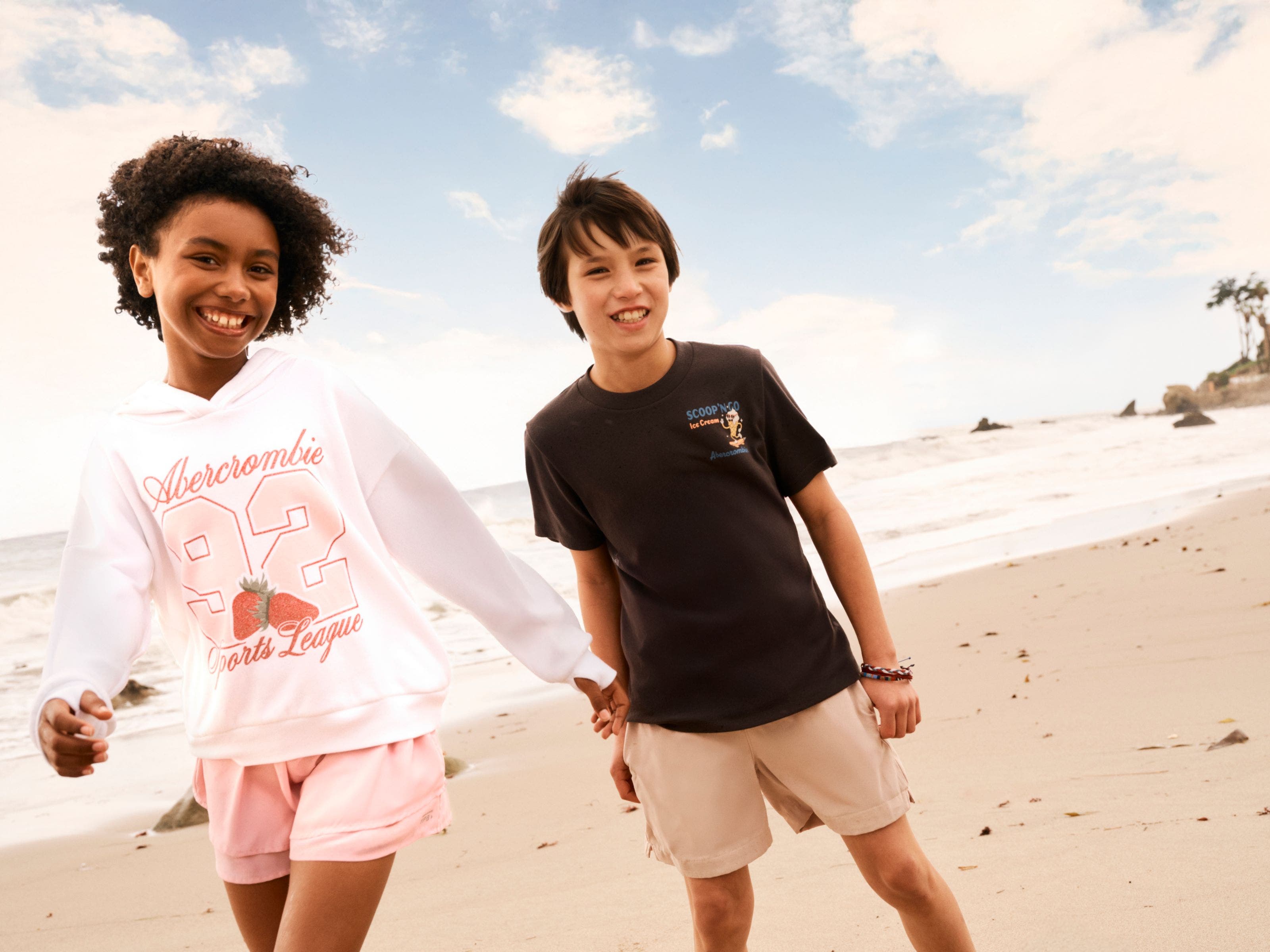 Two kids in Abercrombie shorts and T-shirts at the beach.