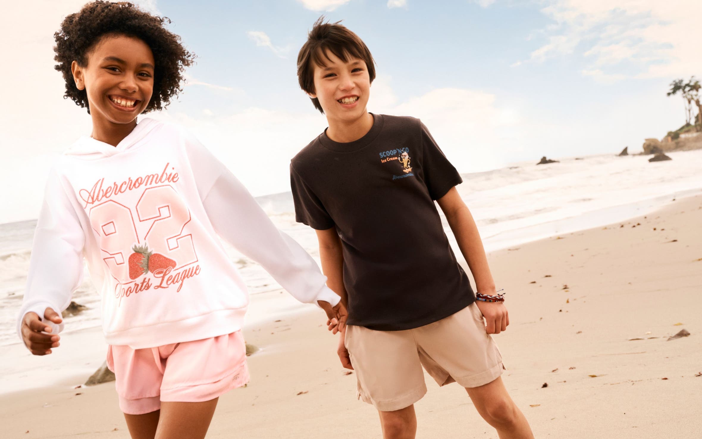 Two kids in Abercrombie shorts and T-shirts at the beach.