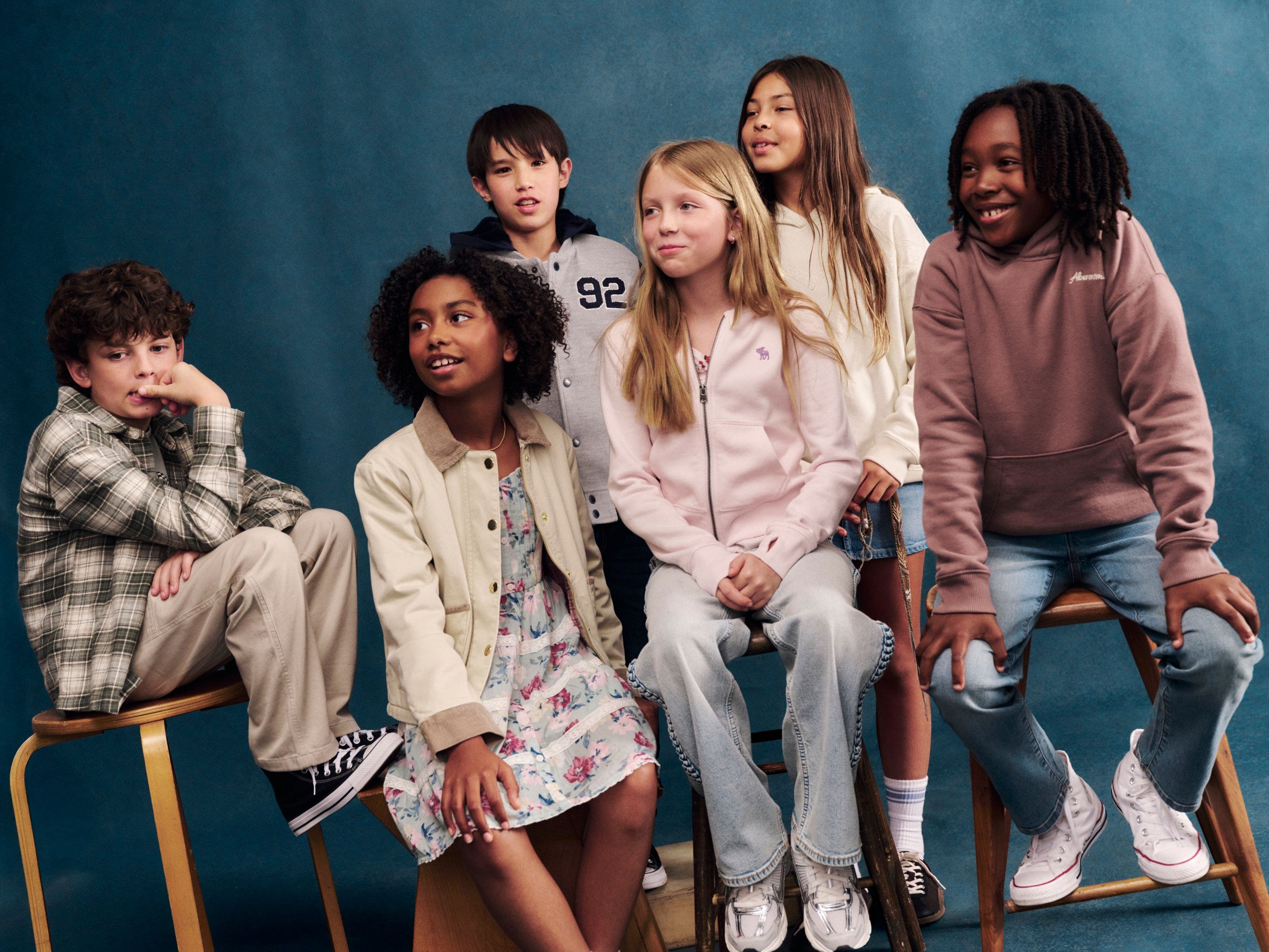 A group of boys and girls wearing abercrombie kids clothing.