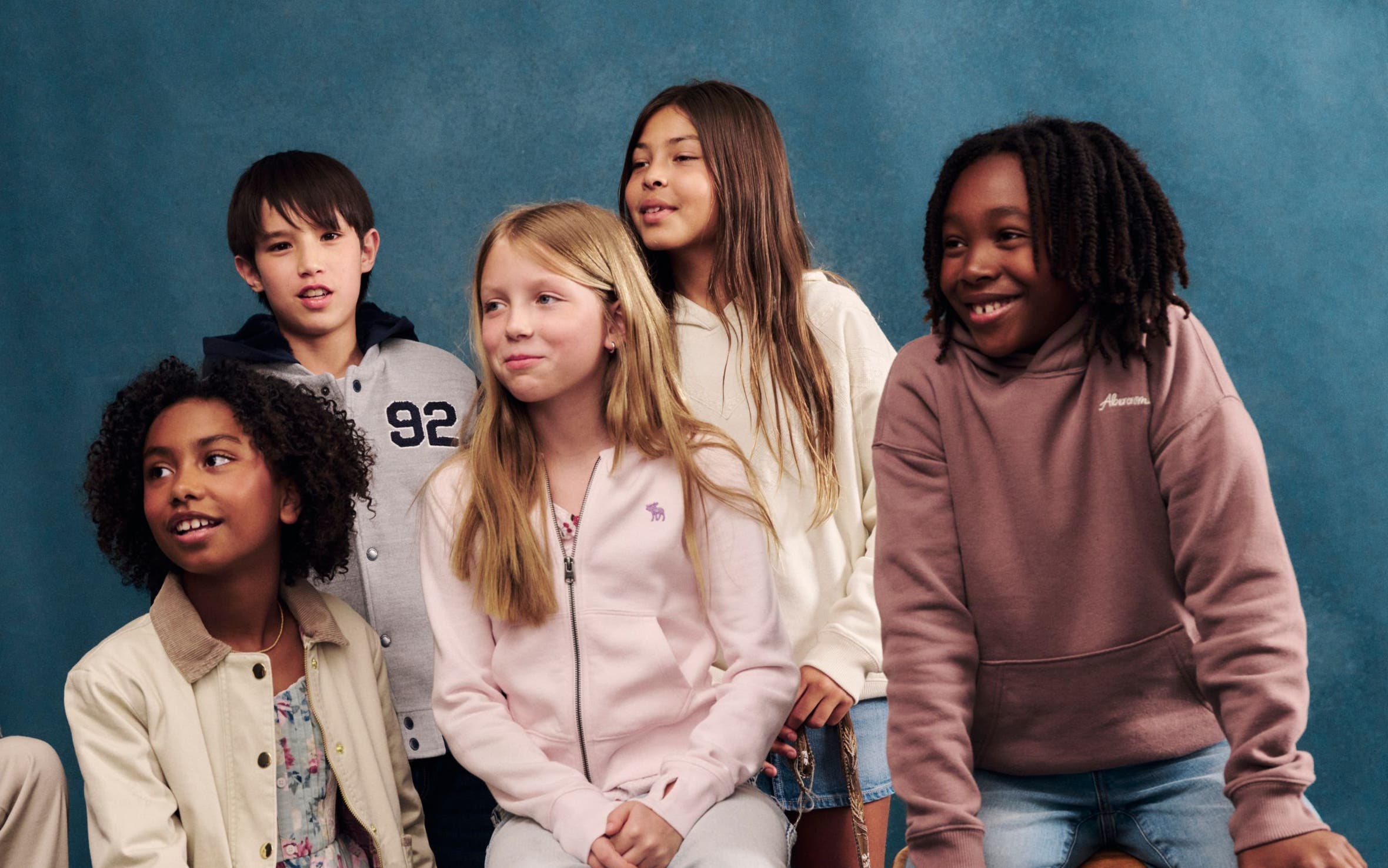 A group of boys and girls wearing abercrombie kids clothing.