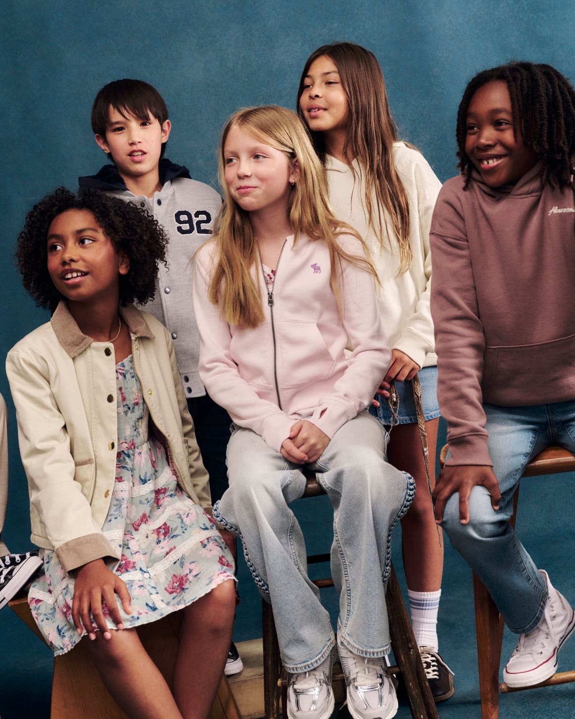 A group of boys and girls wearing abercrombie kids clothing.