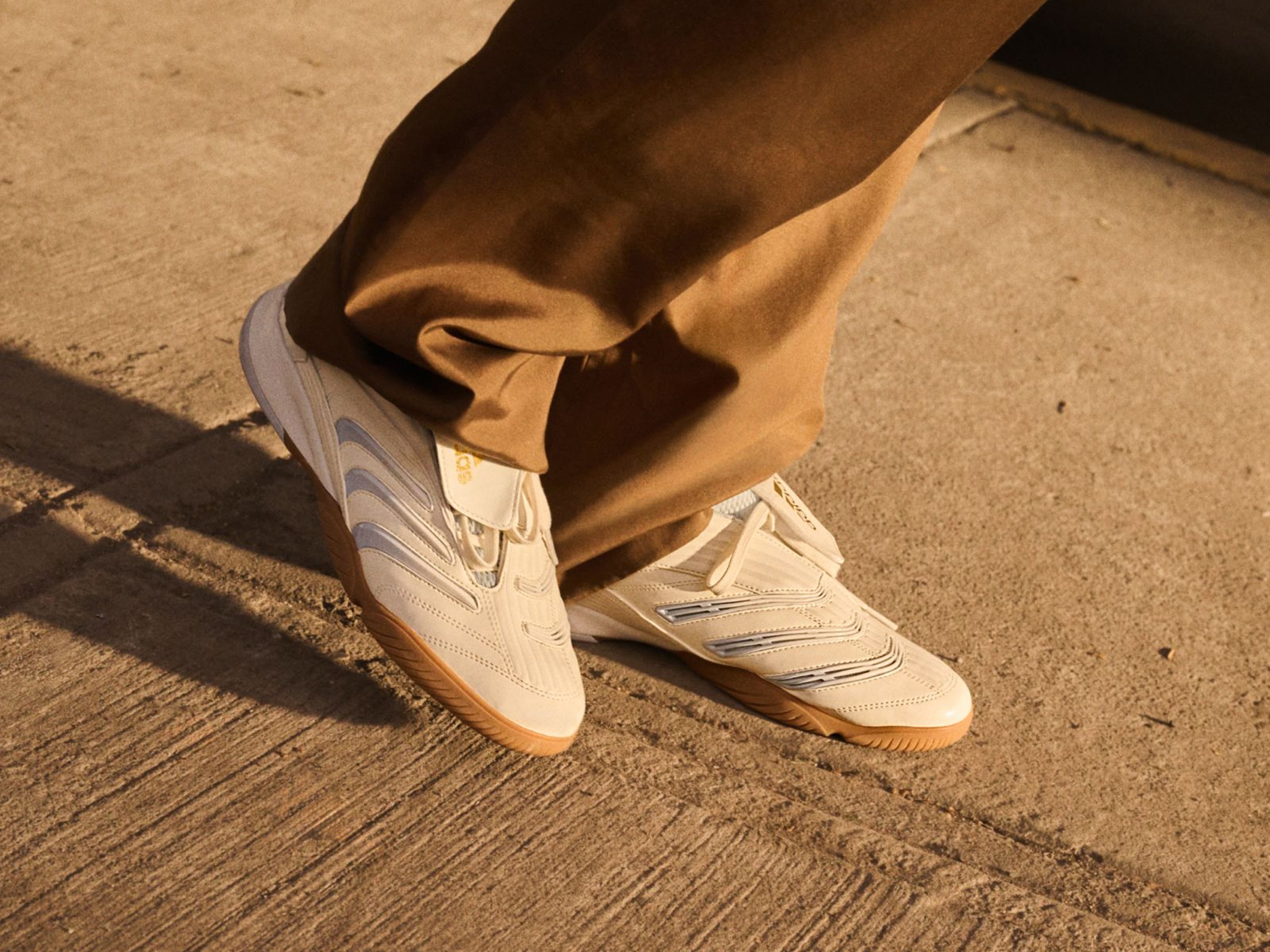 Person wearing adidas pants and sneakers, part of Nordstrom's 125th celebration.