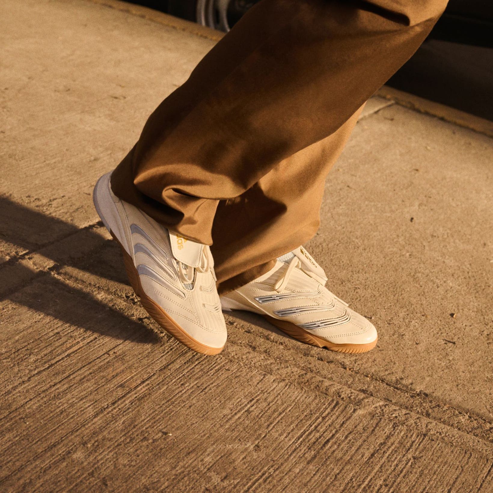 Person wearing adidas pants and sneakers, part of Nordstrom's 125th celebration.