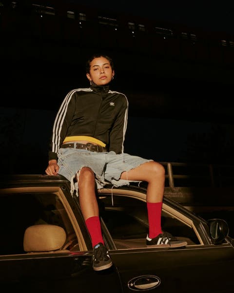 Woman sitting on car.
