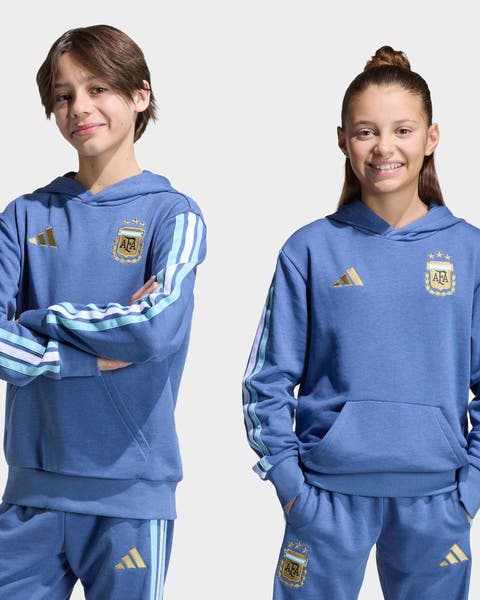 Boy and girl wearing matching adidas sweatsuit.