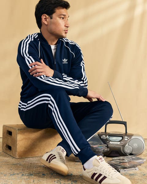 Man wearing adidas tracksuit and shoes