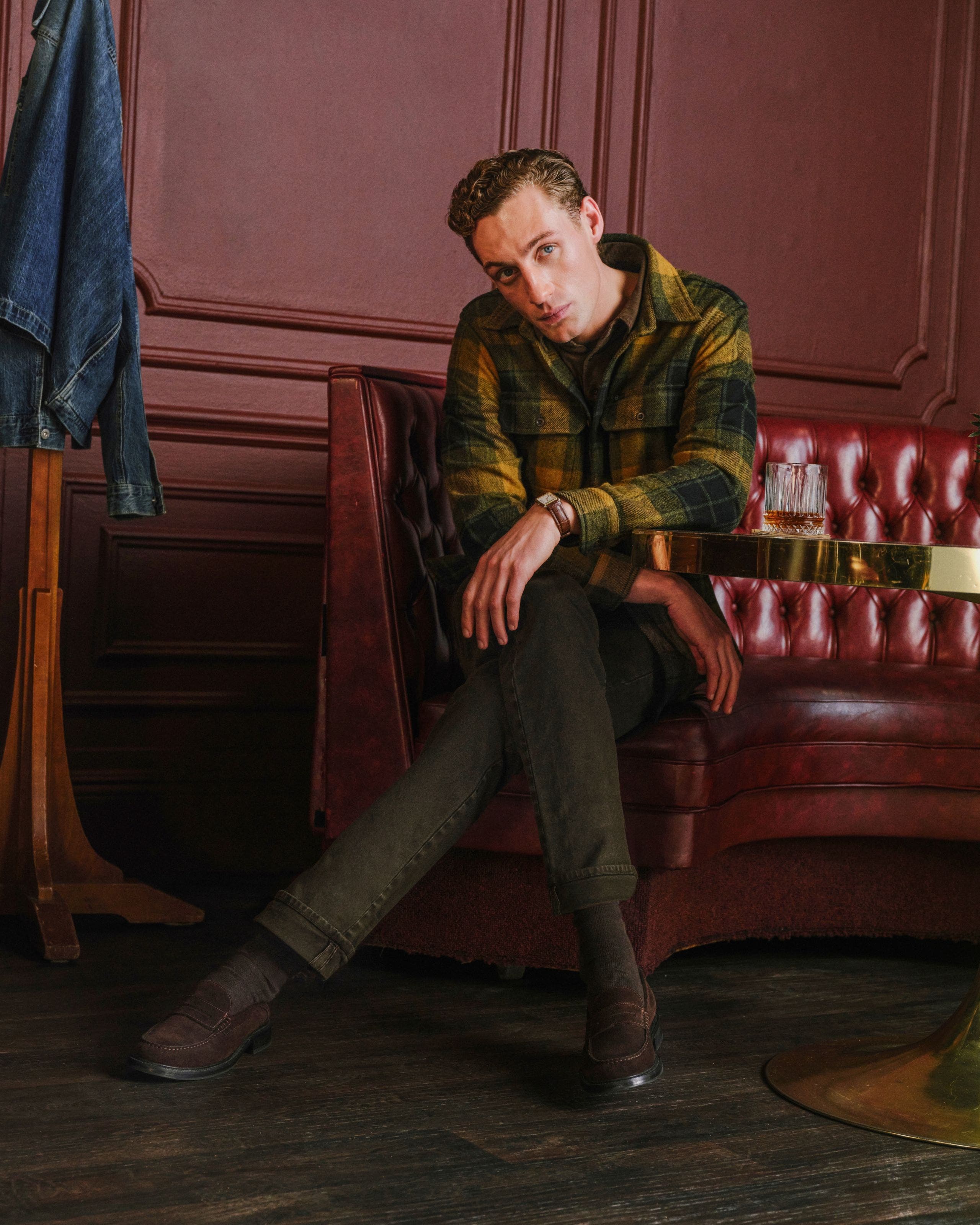 A man wearing flannel and Ag jeans.