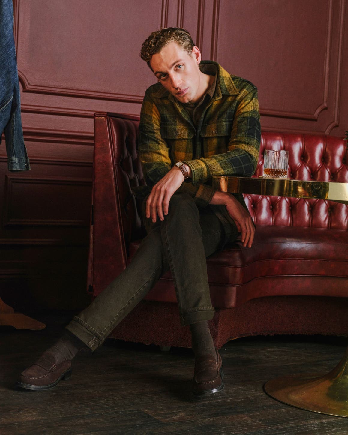 A man wearing flannel and Ag jeans.