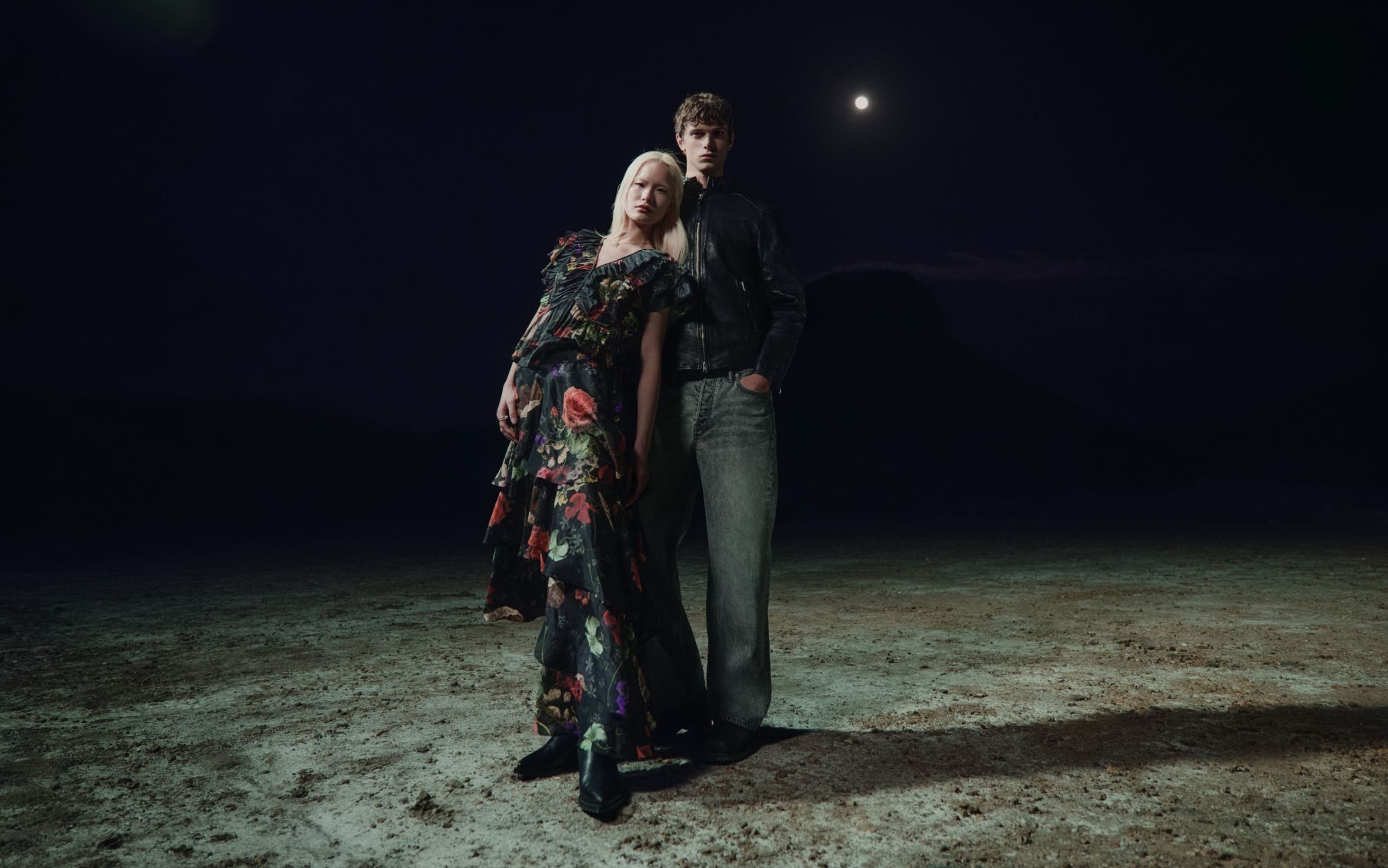 A woman and man in the AllSaints spring collection.