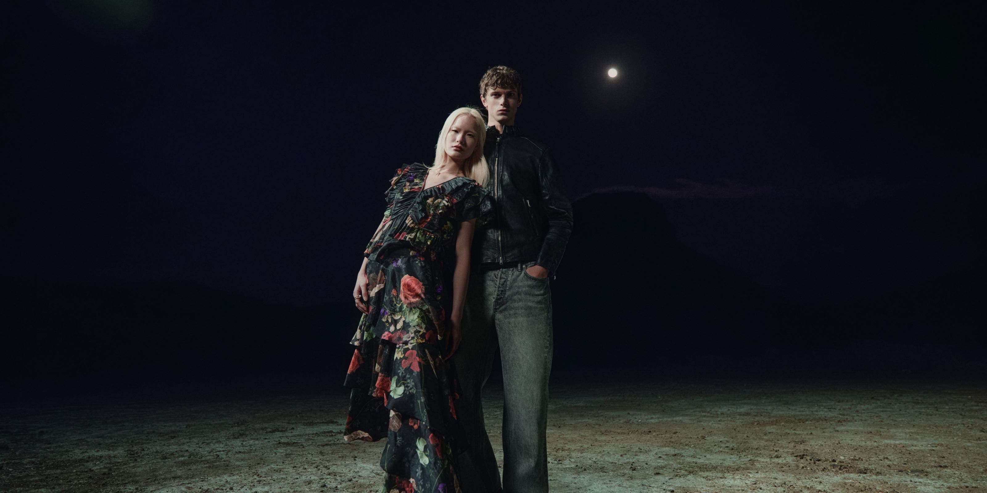 A woman and man in the AllSaints spring collection.