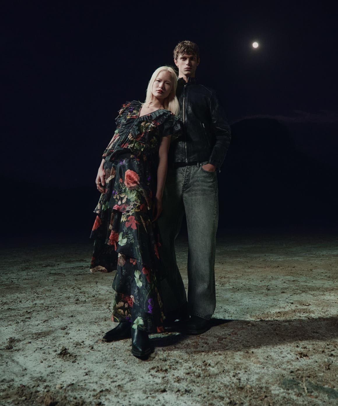 A woman and man in the AllSaints spring collection.