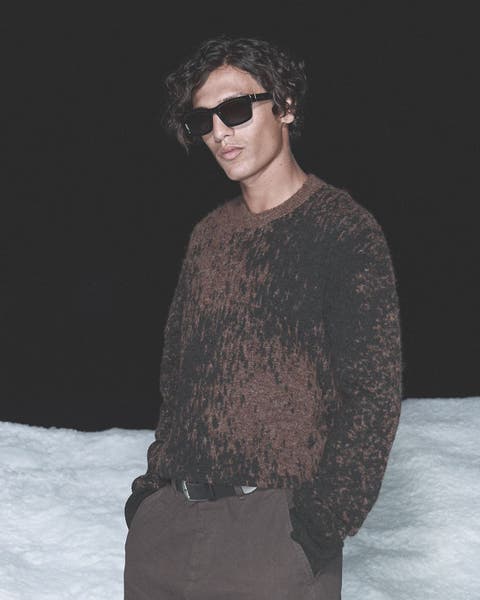 Man wearing sunglasses and AllSaints sweater.