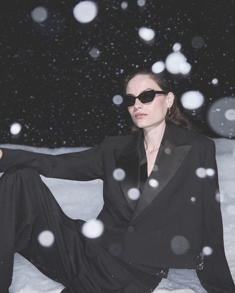 Woman wearing an AllSaints look in the snow.