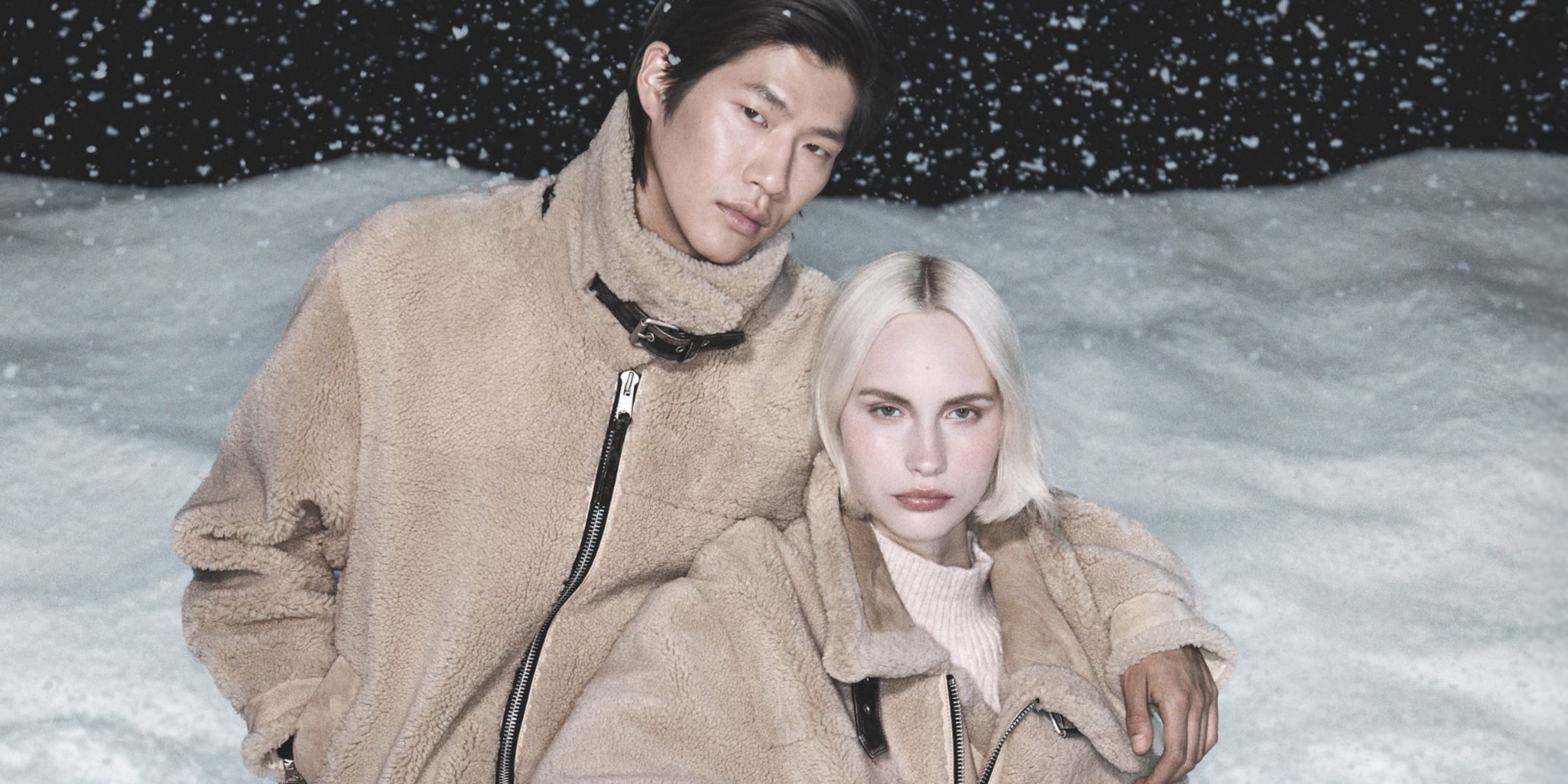 Man and woman wearing AllSaints coats.