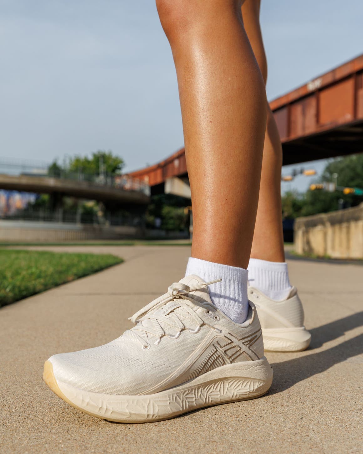 Woman wearing ASICS® sneakers.