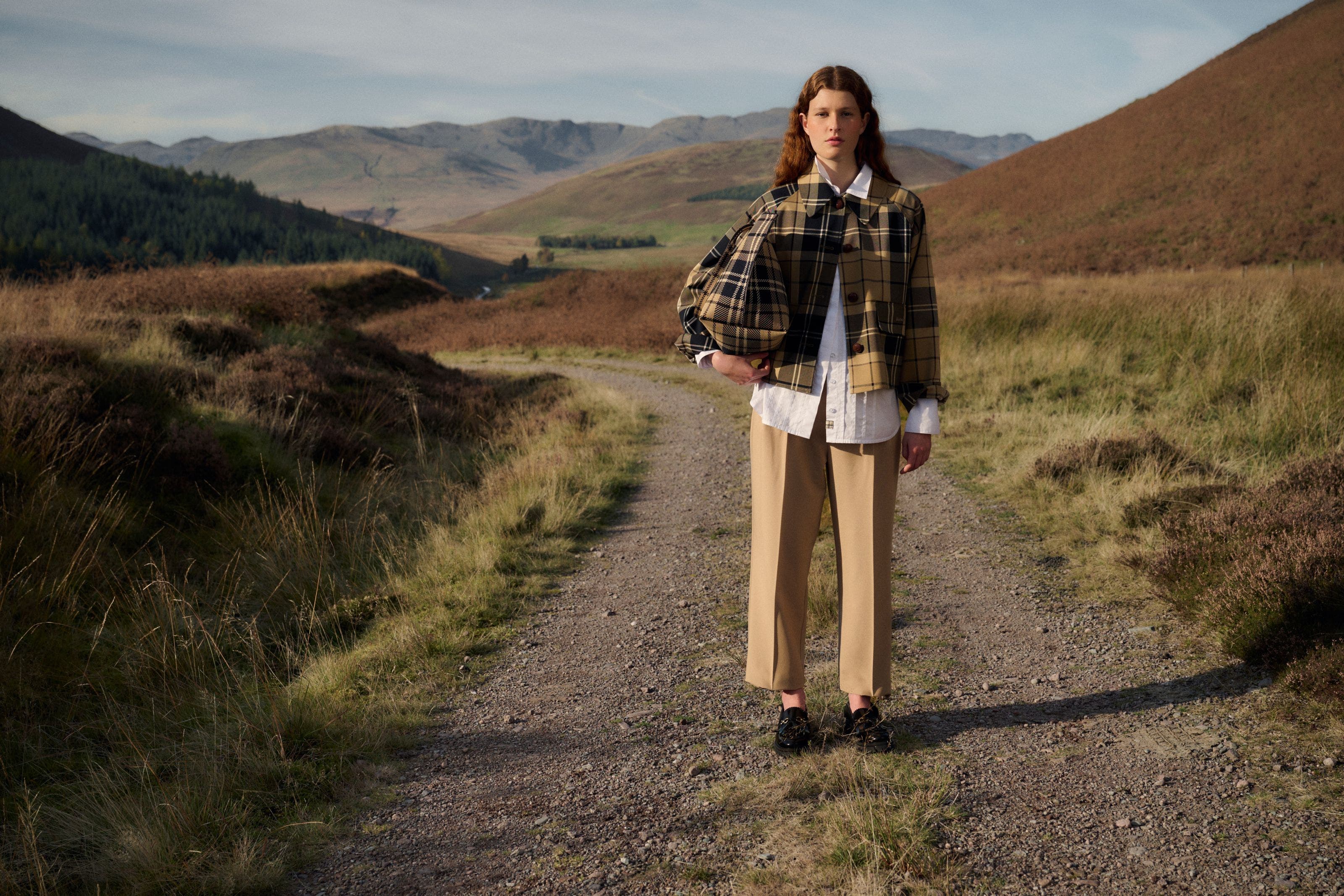 A woman wearing a tartan Barbour jacket.