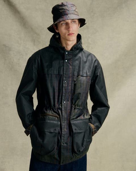 Image of man wearing Barbour raincoat. 