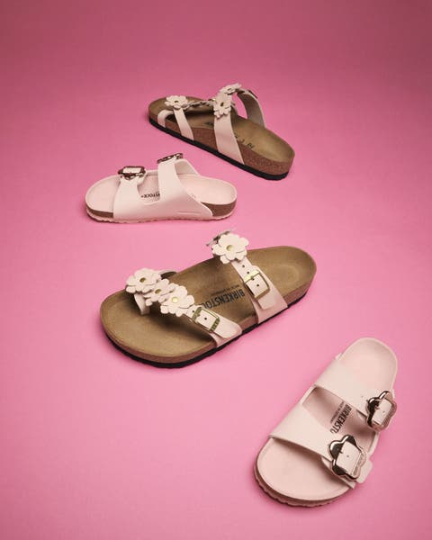Sandals with flowers on the straps and large buckles.