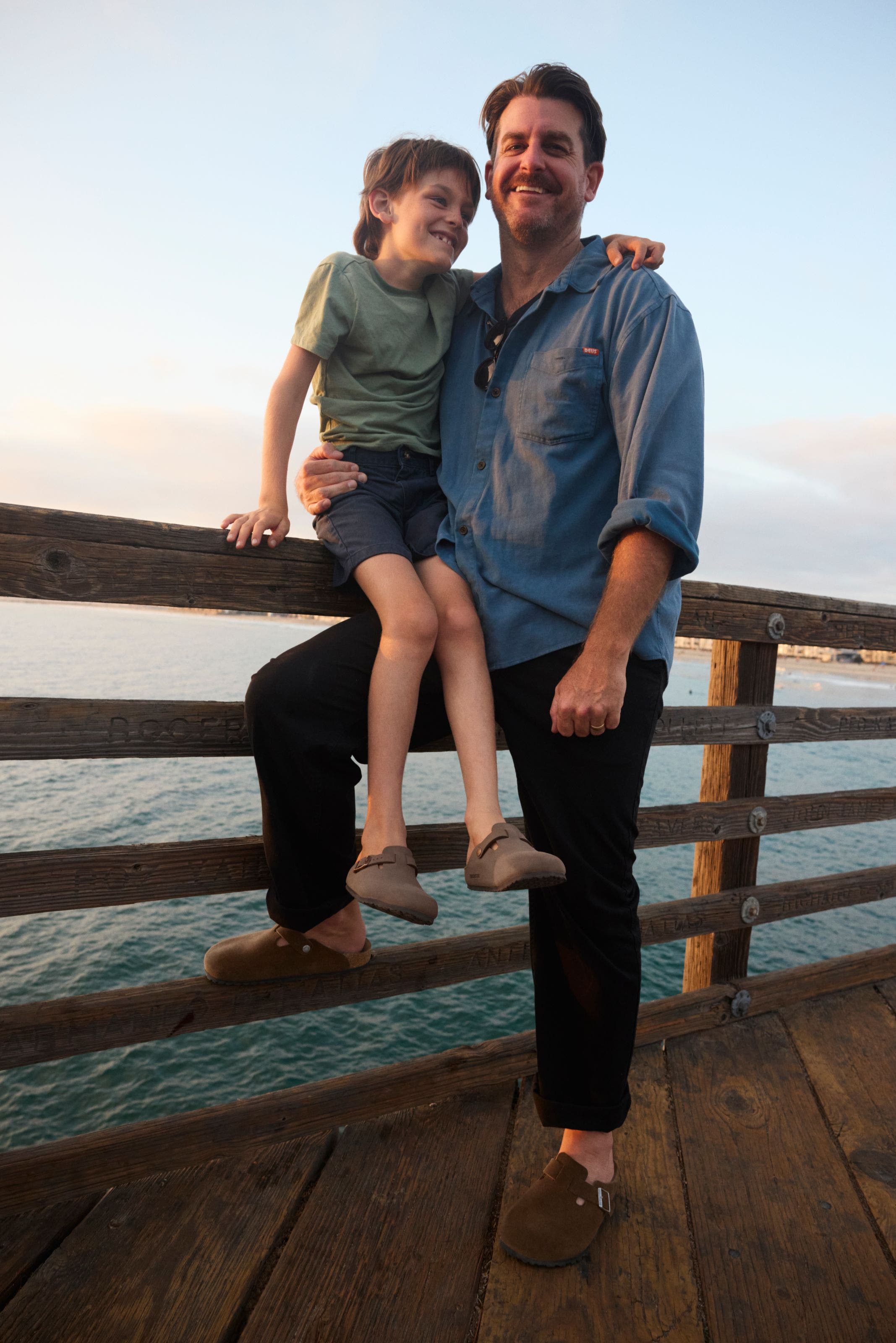 A man and child wear birkenstock sandals.