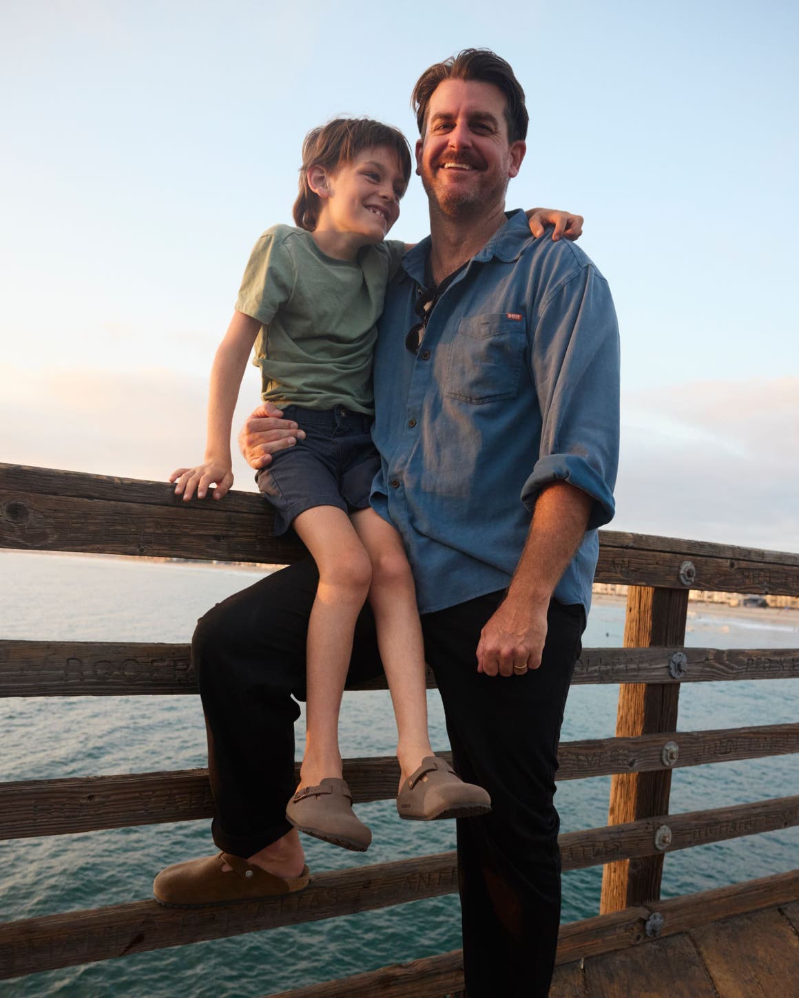 A man and child wear birkenstock sandals.