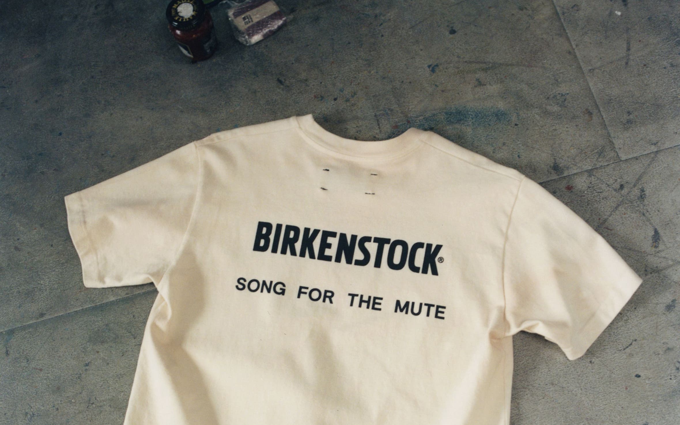 Birkenstock and Song for the Mute collaboration t-shirt.