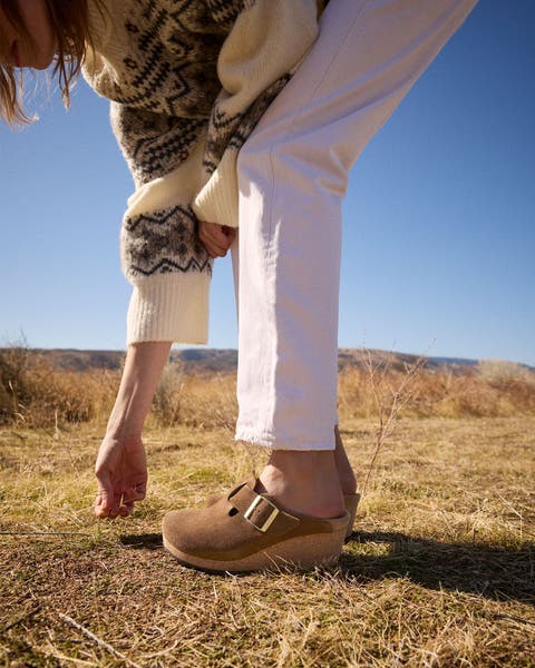 Woman bending in clogs.